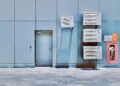 a couple of air conditioners sitting on the side of a building