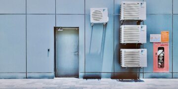 a couple of air conditioners sitting on the side of a building