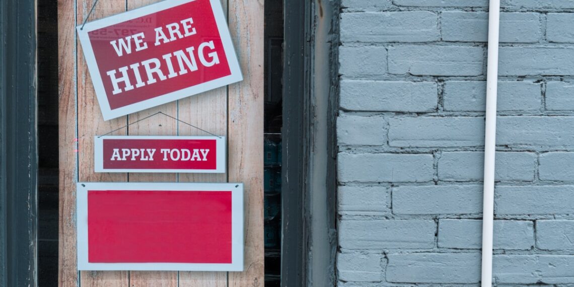a sign that says we are hiring and apply today