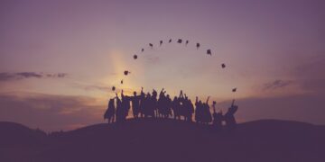 silhouette of people standing on hill