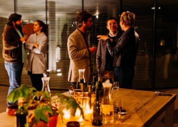 five person standing while talking each other